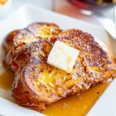A close up of butter topped slices of French toast