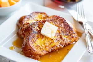 A close up of butter topped slices of French toast