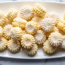 A plate of little lemon cookies dusted with powdered sugar