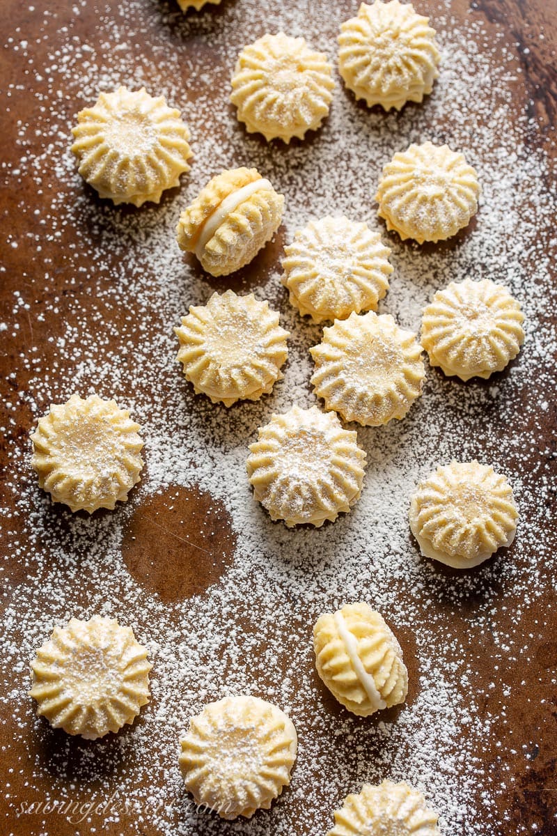 A cookie sheet with little lemon cookies dusted with powdered sugar