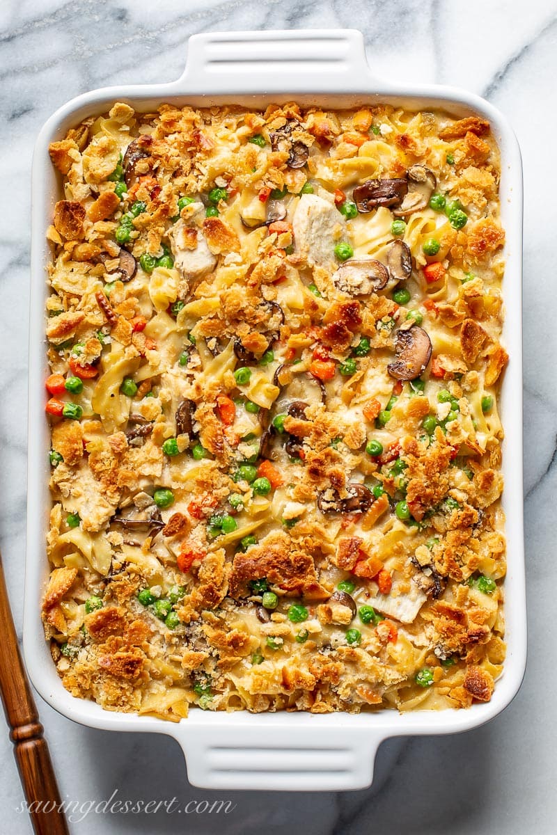 Casserole filled with chicken, noodles, peas, carrots and mushrooms topped with crushed golden brown crackers