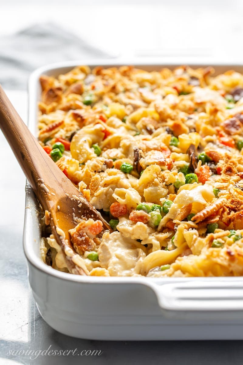 A spoon scooping a portion of chicken noodle casserole