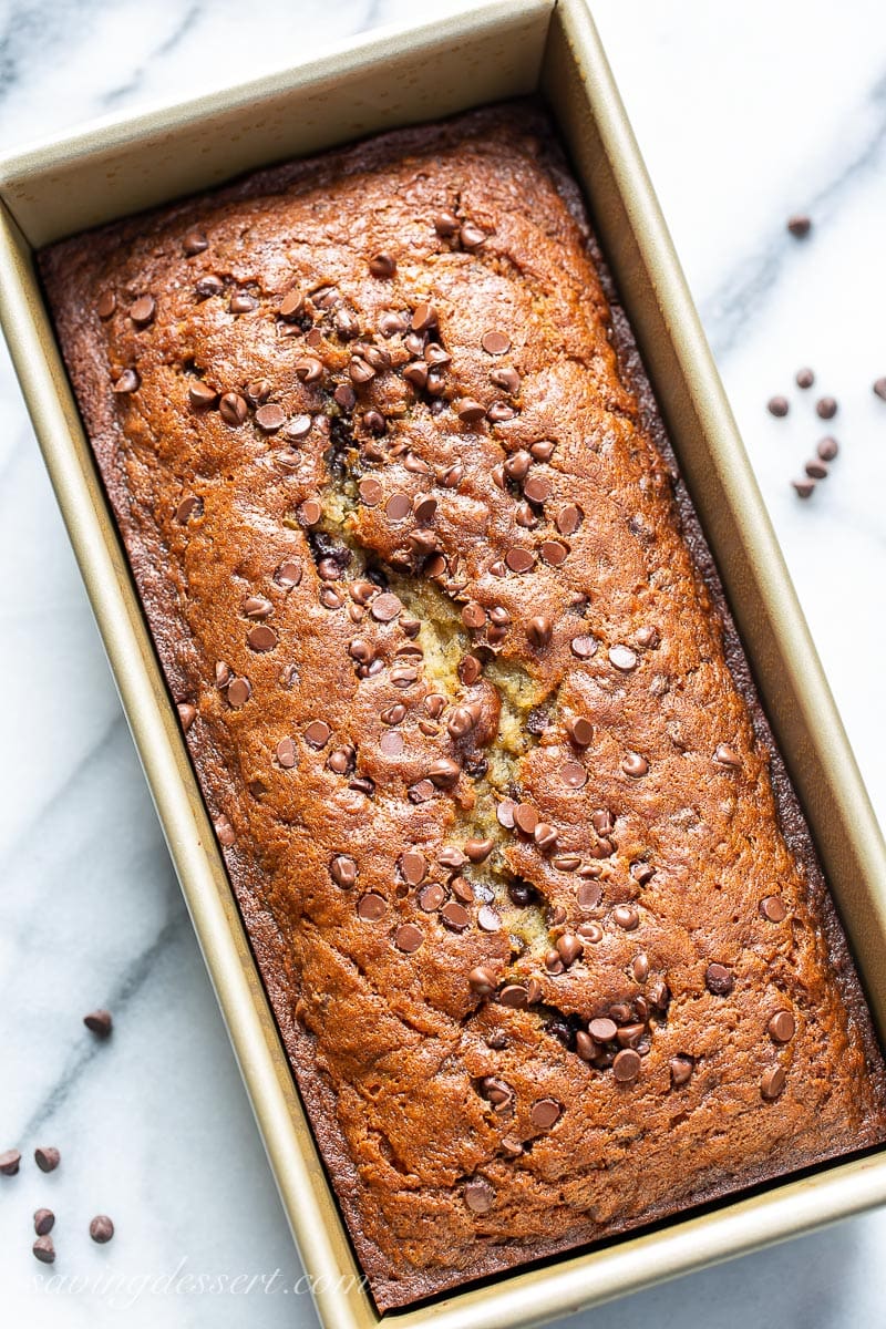 A golden brown loaf of quick bread sprinkled with mini chocolate chips