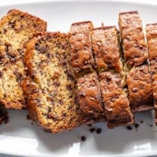 Overhead view of a platter of sliced banana bread with chocolate chips