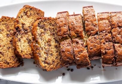 Overhead view of a platter of sliced banana bread with chocolate chips