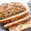 A sliced loaf of cranberry raisin bread