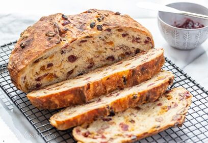 A sliced loaf of cranberry raisin bread