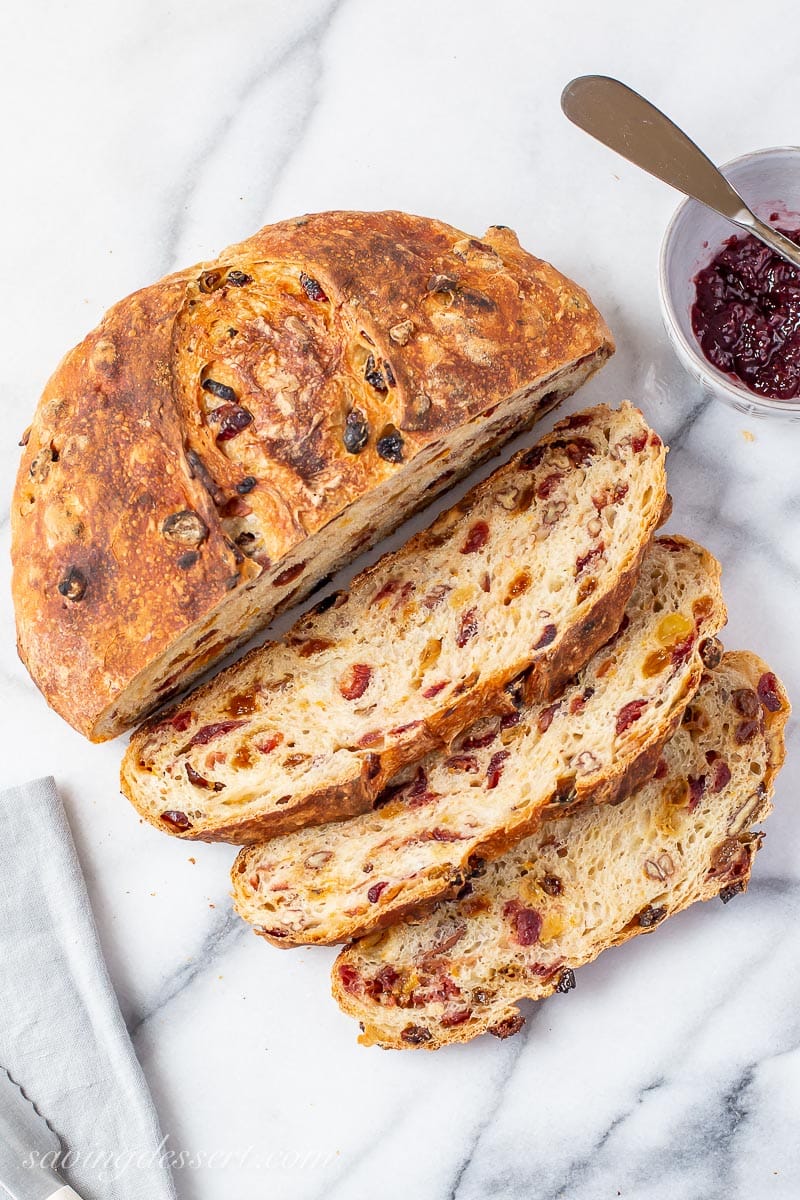 An overhead view of a slice loaf of rustic Harvest Bread with cranberries and raisins