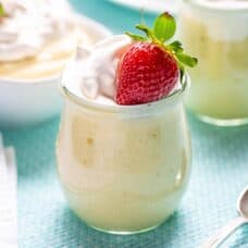 Homemade vanilla pudding in a jar topped with a strawberry