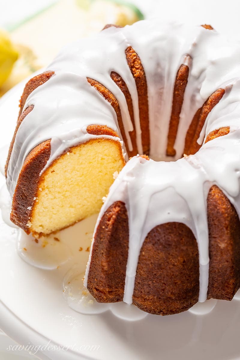 A sliced lemon cake drizzled with icing