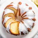 An overhead view of a sliced Lemon Bundt Cake topped with a drizzled icing