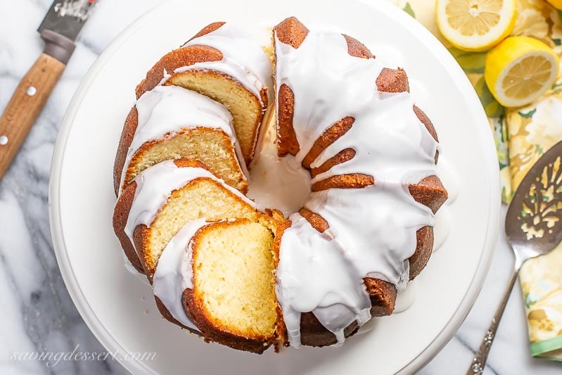 An overhead view of a sliced Lemon Bundt Cake topped with a drizzled icing