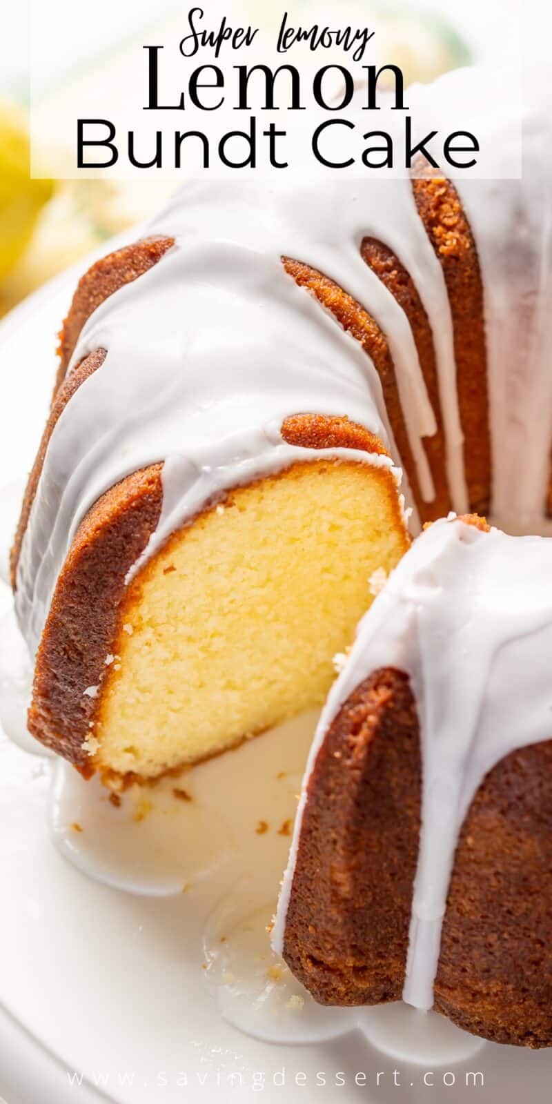 A side view of a sliced lemon bundt cake drizzled with lemon icing