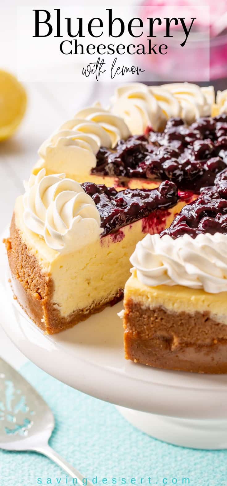 A cheesecake on a stand with a slice cut out