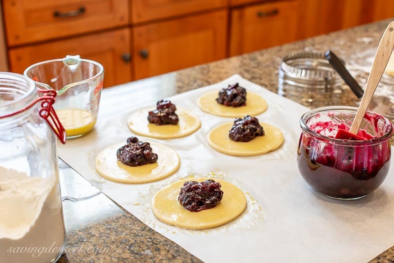 Pastry rounds with a dollop of blueberry sauce in the middle of each