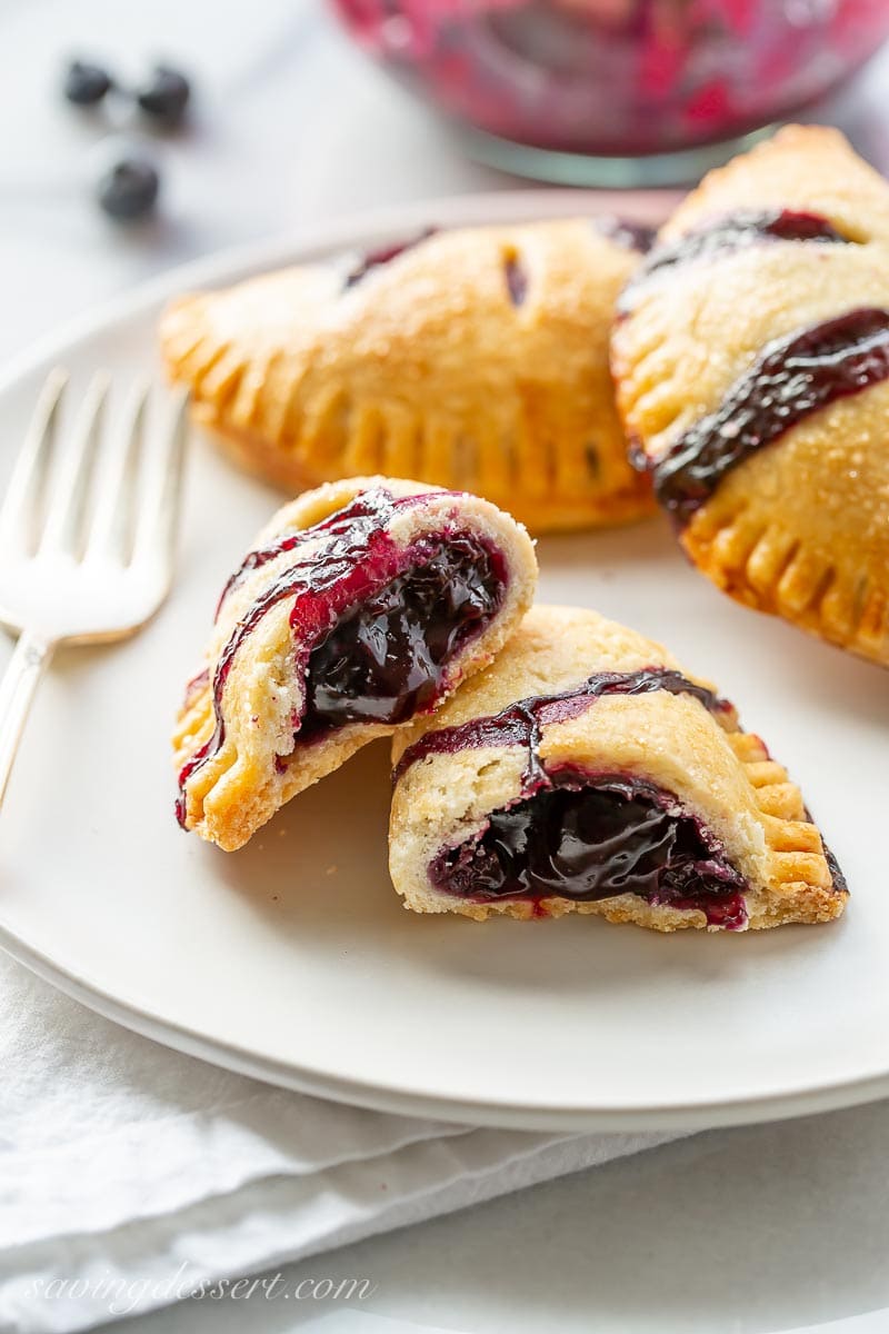 Blueberry hand pie broken open showing a jammy filling