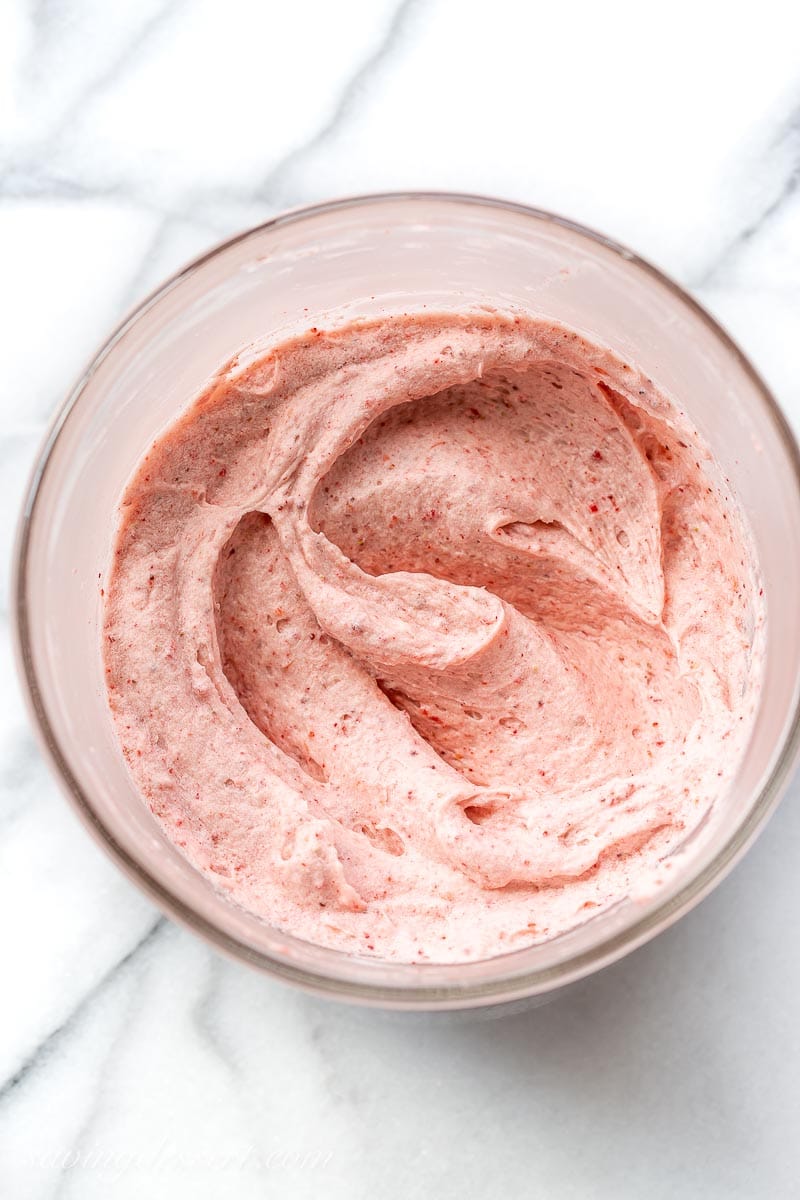 A bowl of strawberry buttercream icing