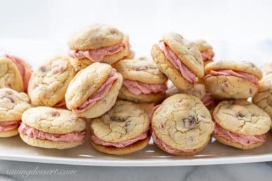 A platter of strawberry buttercream filled strawberry cookies