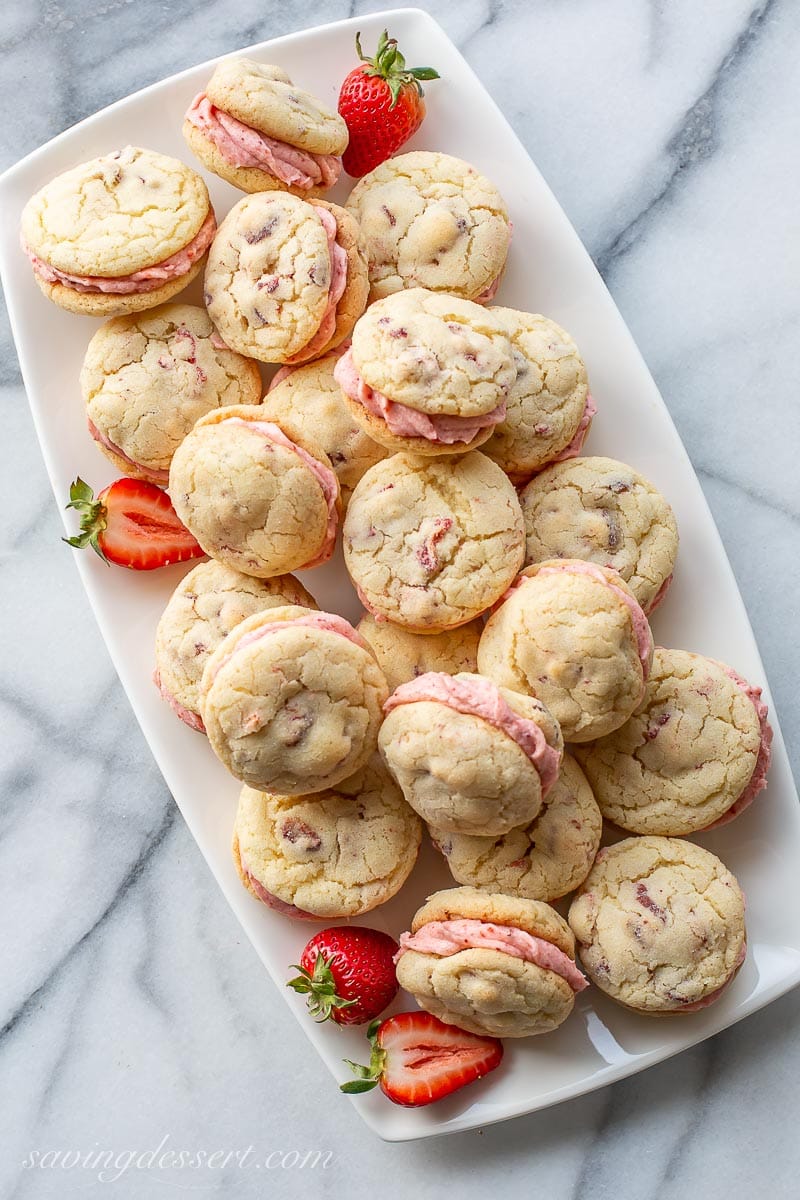 An overhead view of a platter of strawberry cream filled cookies