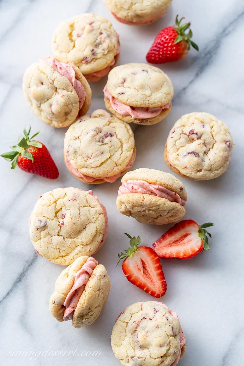 Strawberry Cookies with a strawberry buttercream filling on a marble counter