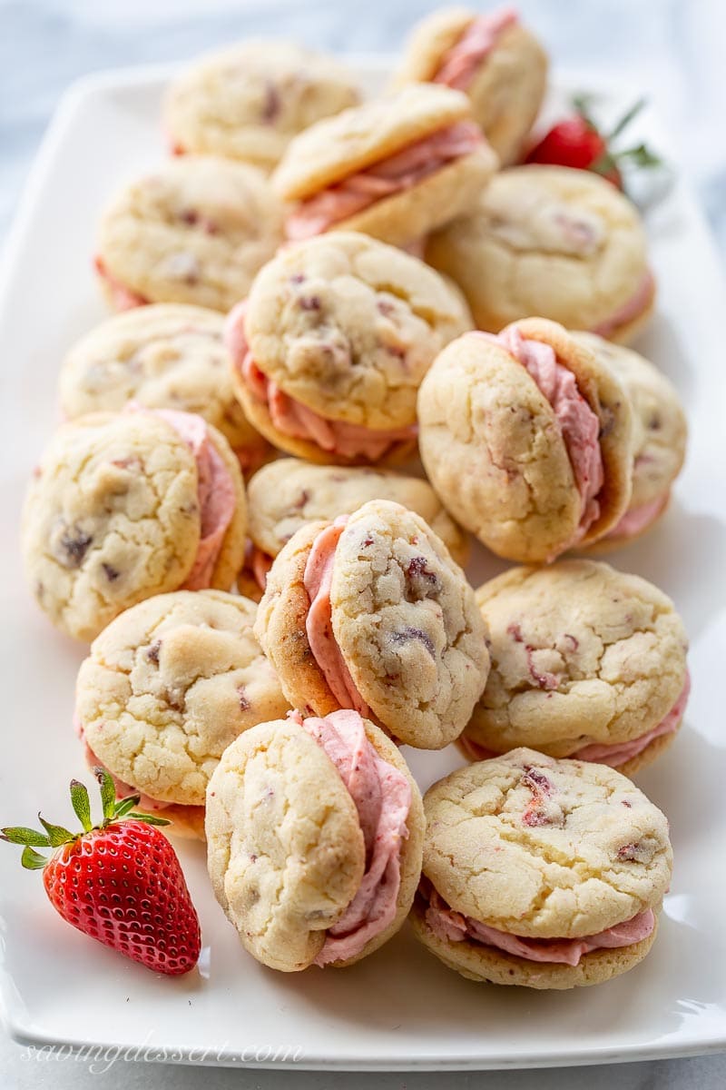 A platter of strawberry sandwich cookies with strawberry buttercream
