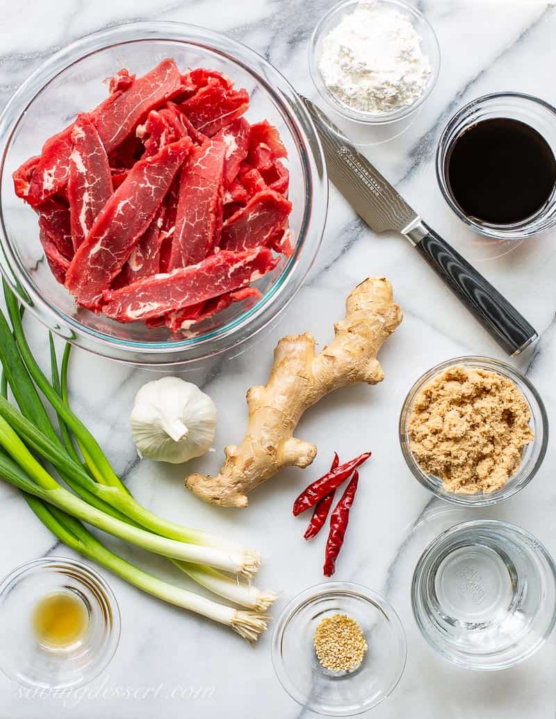 Ingredients used to make Mongolian Beef with green onions, ginger, arbol chiles and sliced flank steak