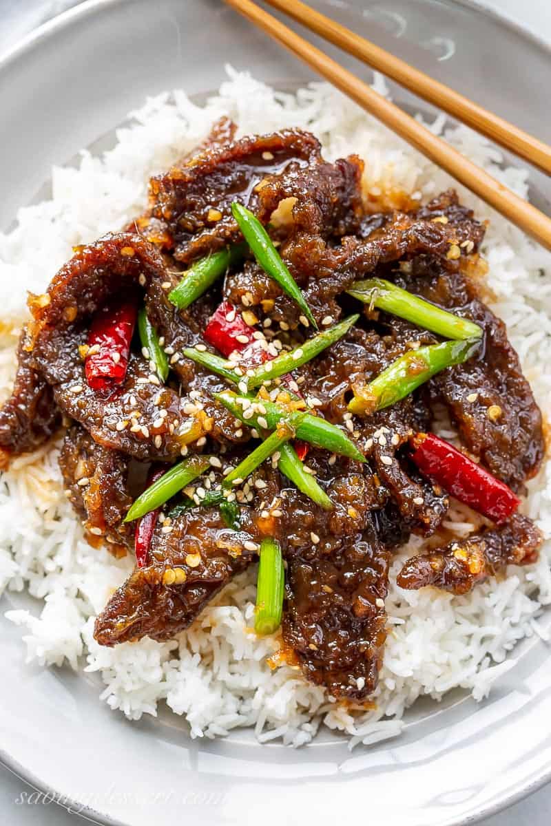 Close up of homemade Mongolian Beef with green onions and arbol chiles