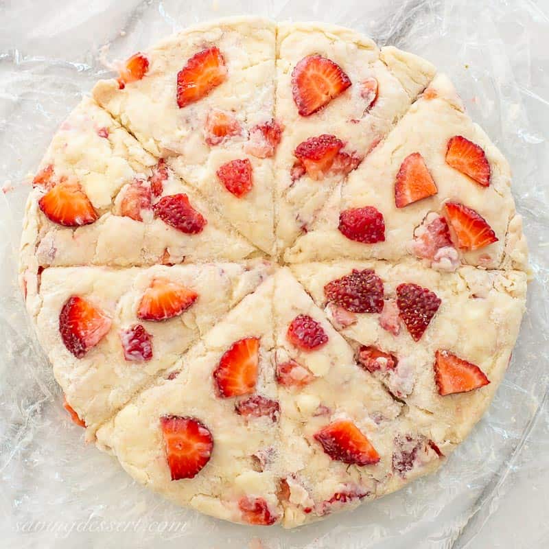 A round of dough studded with strawberries and cut into wedges