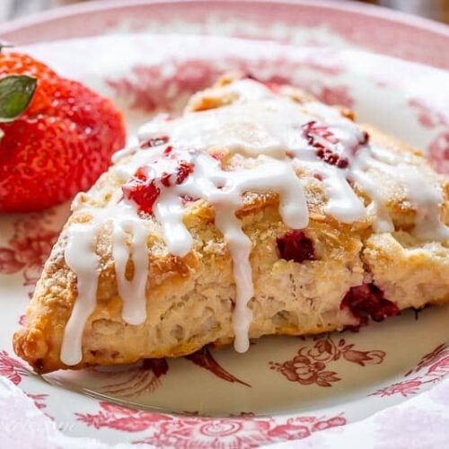 An iced strawberry scone on a plate