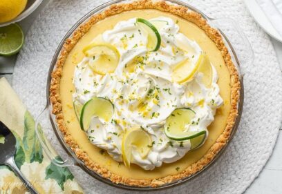 A whole Atlantic Beach Pie topped with lemons, limes and whipped cream