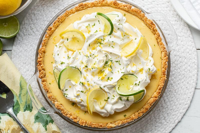 A whole Atlantic Beach Pie topped with lemons, limes and whipped cream