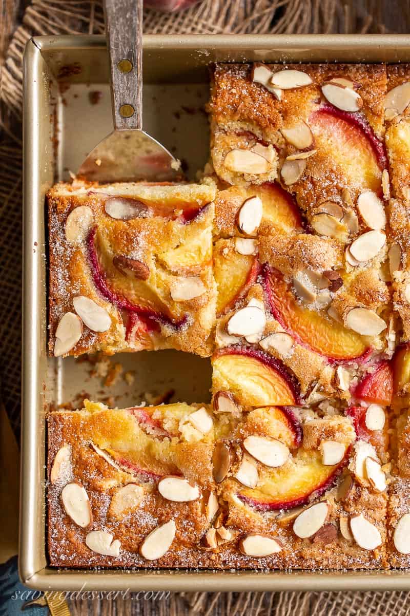 A square piece of peach cake cut from a pan