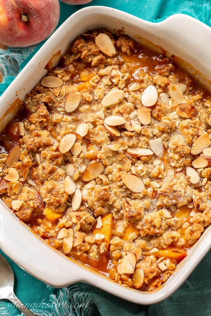 Overhead view of a pan of Peach Crisp with almonds and oats