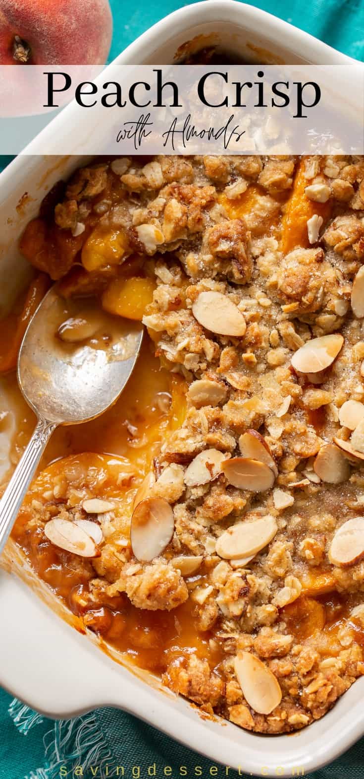 Overhead view of a square casserole dish filled with peach crisp with oats and sliced almonds