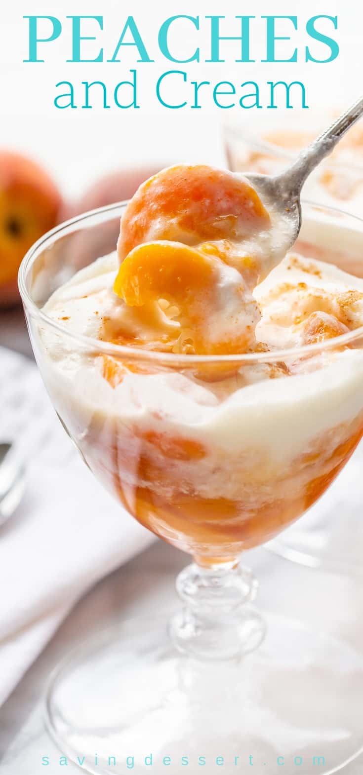 A stemmed glass of sliced peaches with cream