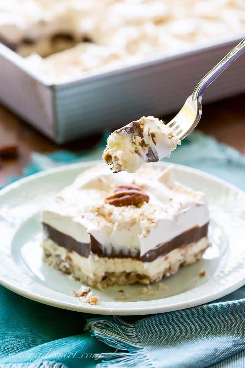 A fork with a piece of Chocolate Delight and a slice in the background