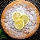 Overhead view of a golden brown lemon cake on a cooling rack