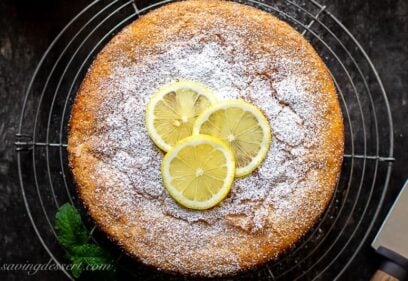 Overhead view of a golden brown lemon cake on a cooling rack