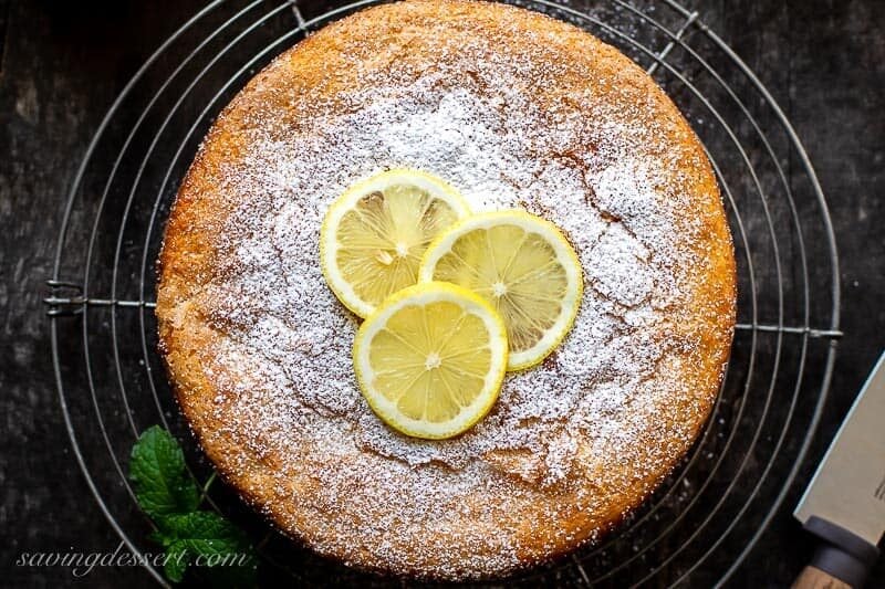 Overhead view of a golden brown lemon cake on a cooling rack