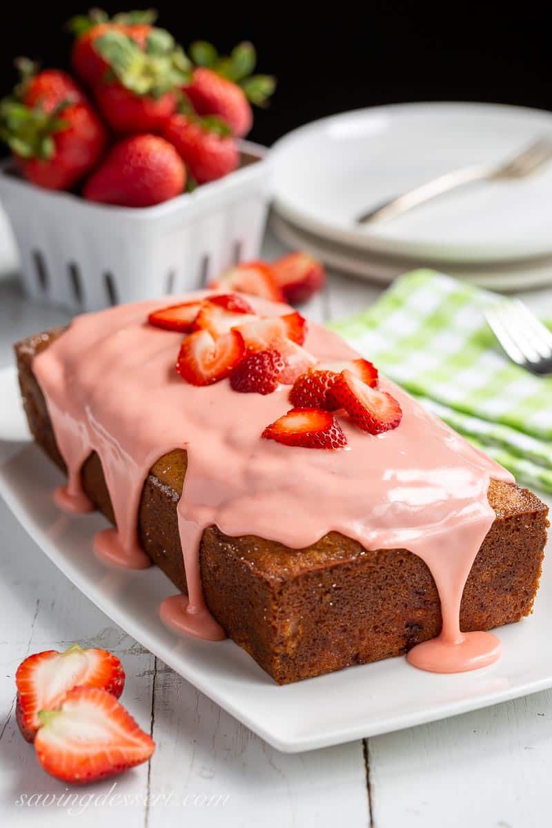 A loaf of strawberry bread drizzled with strawberry icing