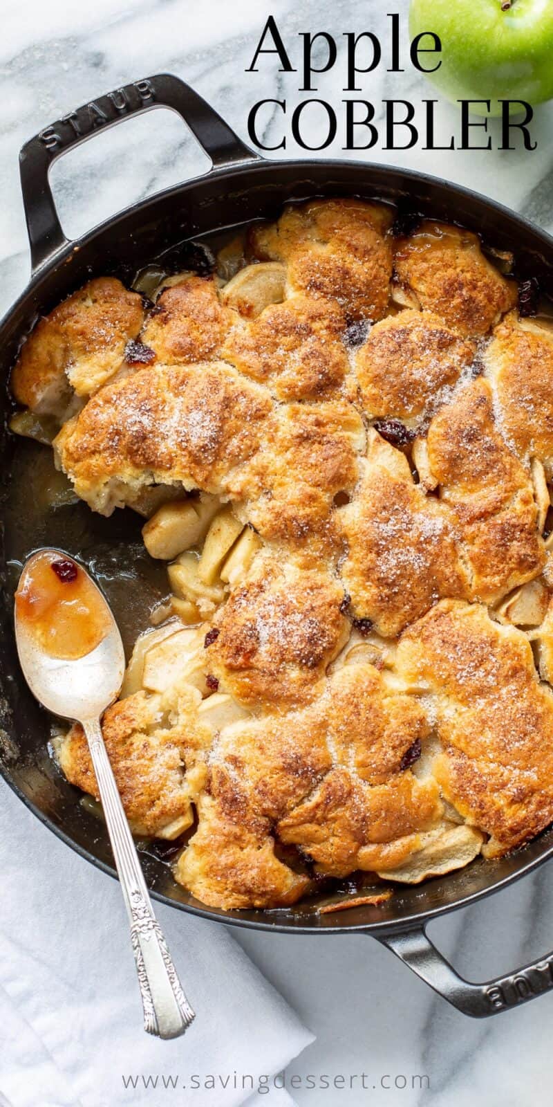 A skillet filled with rustic apple cobbler with cranberries