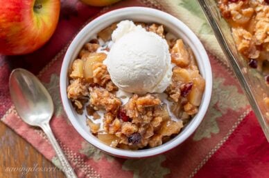 Overhead view of a ramekin filled with apple crisp and ice cream
