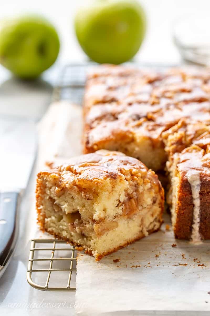 Closeup shot of a corner piece of apple cake drizzled with icing