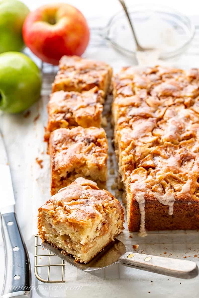 Overhead view of a sliced square apple fritter cake on a cooling rack