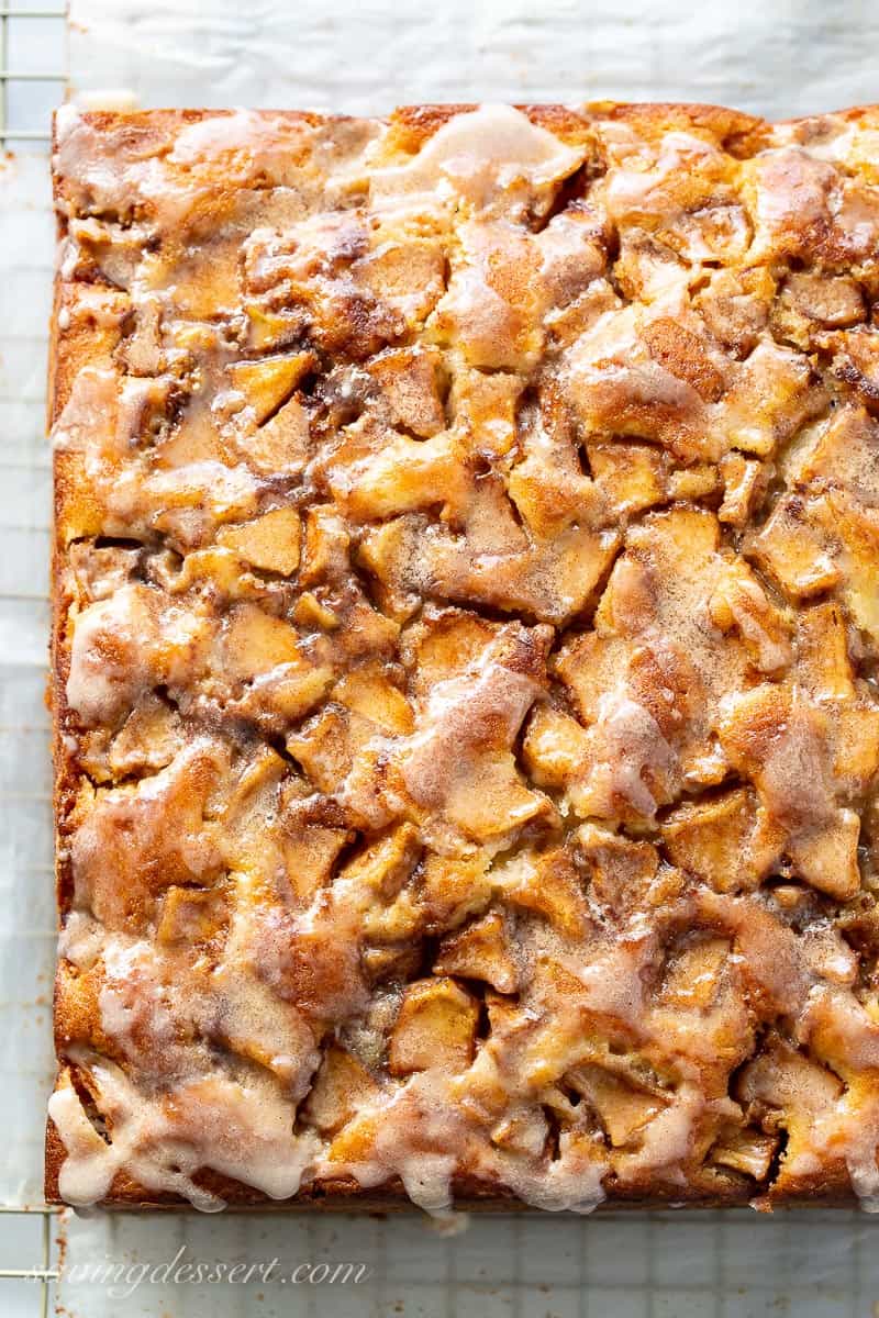 Overhead view of a baked apple fritter cake drizzled with icing