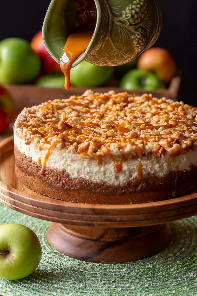 Caramel Apple Cheesecake being drizzled with caramel