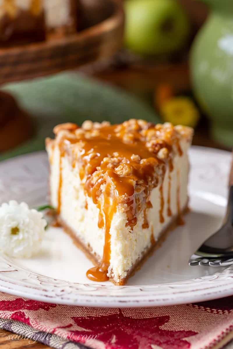 Closeup of caramel apple cheesecake on a plate with a fork