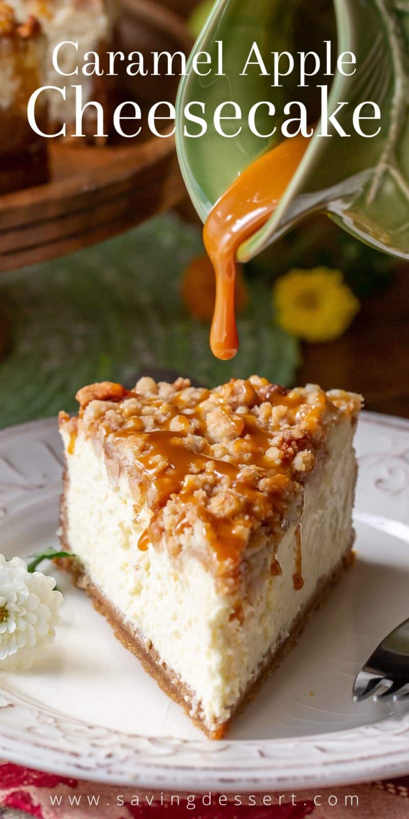 A slice of apple crumble cheesecake being drizzled with caramel sauce
