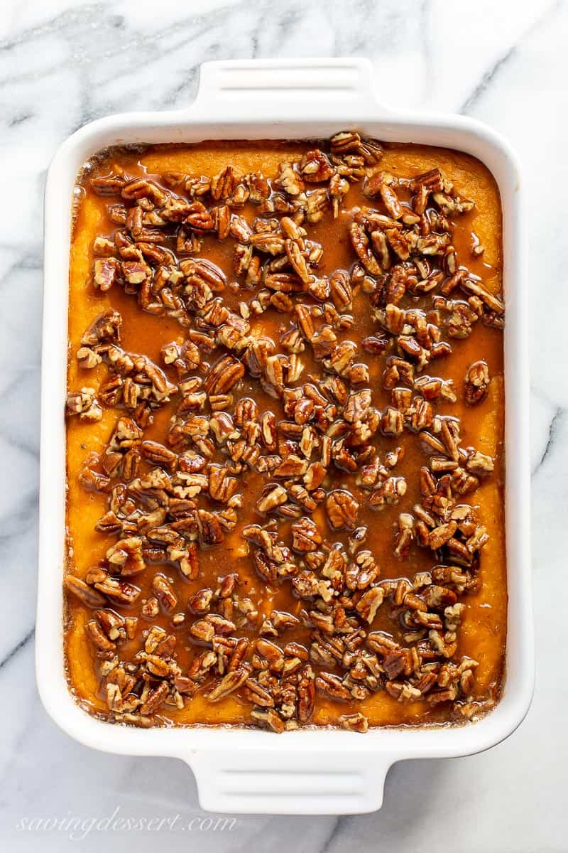 Sweet potato casserole in a rectangular baking dish with pecans on top