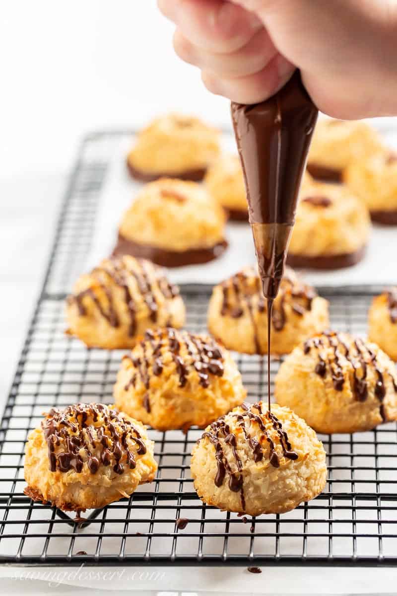 Coconut macaroon recipe being drizzled with melted chocolate